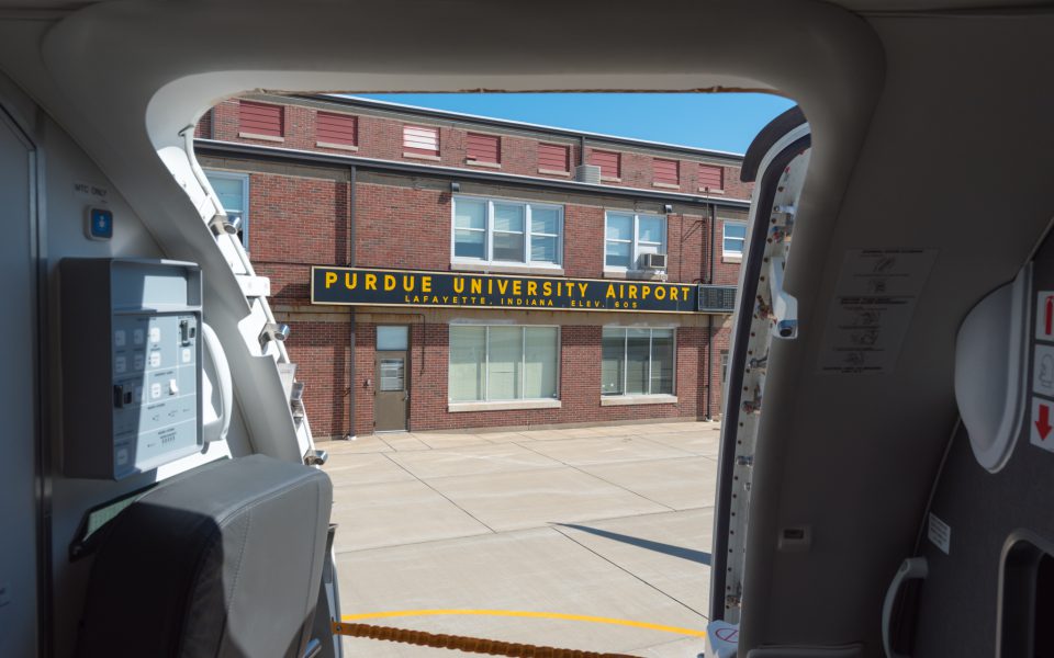 Purdue university airport sign as seen from an Envoy E175 aircraft exit door