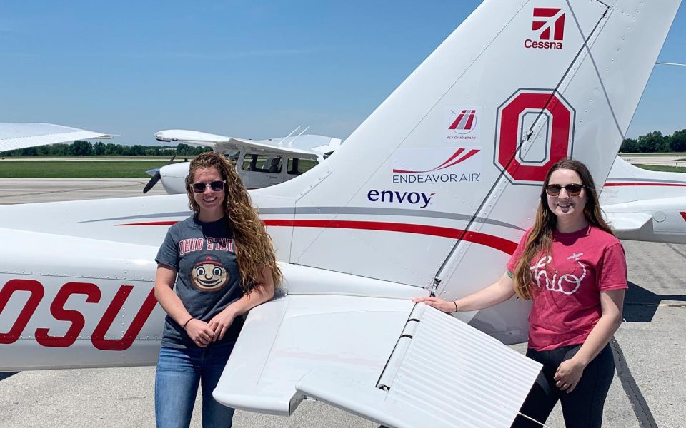 OSU Flight Team posing with OSU and Envoy branded Cessna