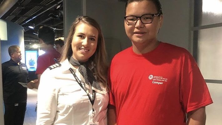 envoy pilot poses with student at cr smith summer camp