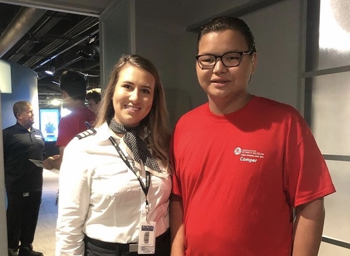 envoy pilot poses with student at cr smith summer camp