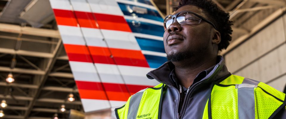 chicago mechanic posing in the maintenance hangar in front of aircraft