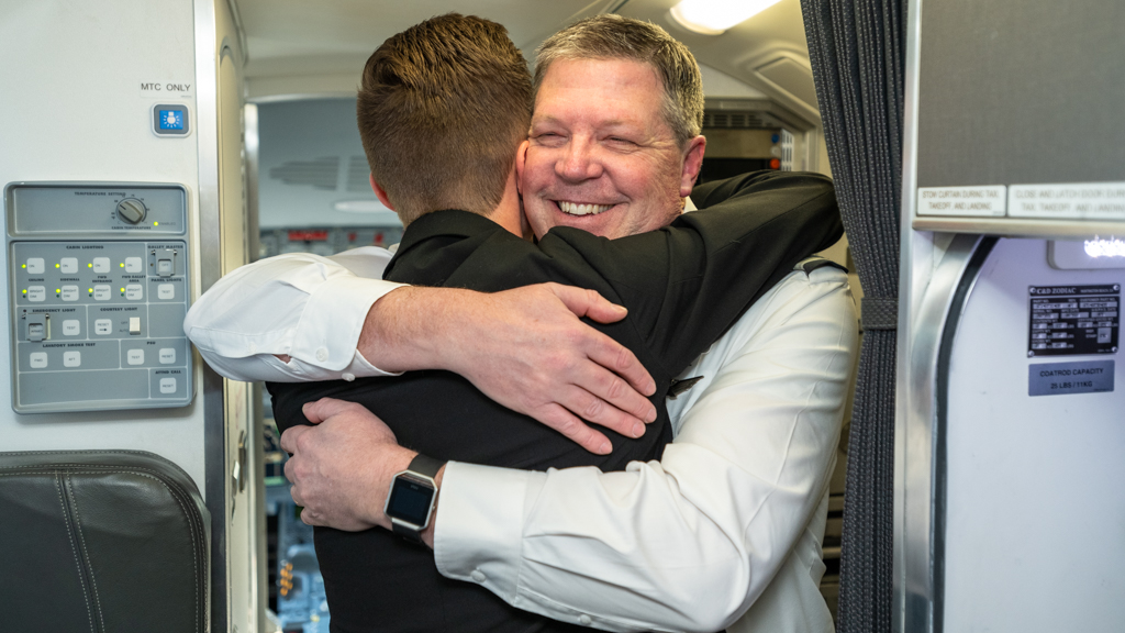 Captain Wilde hugs his son