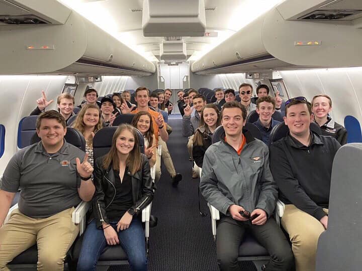 Flying Aggies students pose on a cabin trainer