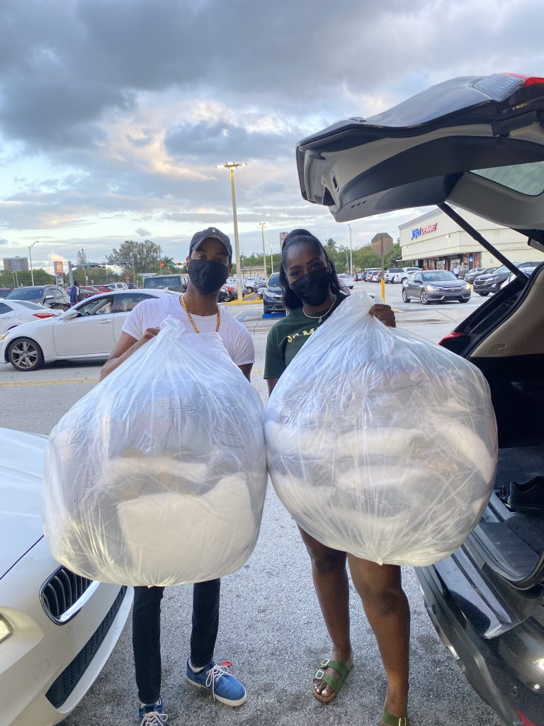 Captain Anselm Dewar (left) with Brandy Jackson, CEO of Bee-Kind (right), with bags of donated blankets and pillows. (Photo courtesy of Anselm Dewar)