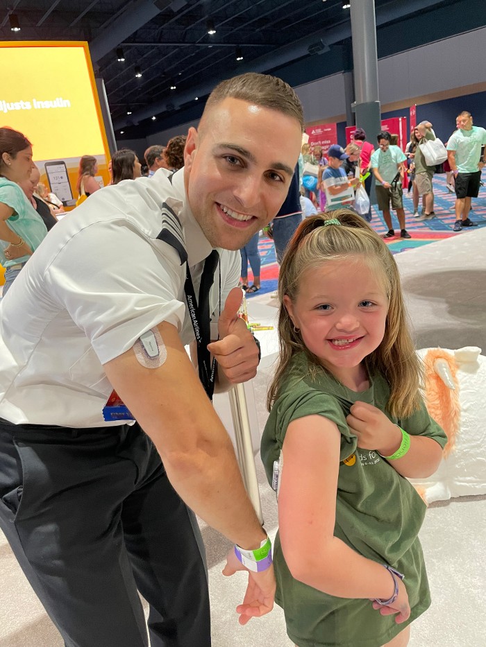 Envoy pilot with young girl at diabetes conference