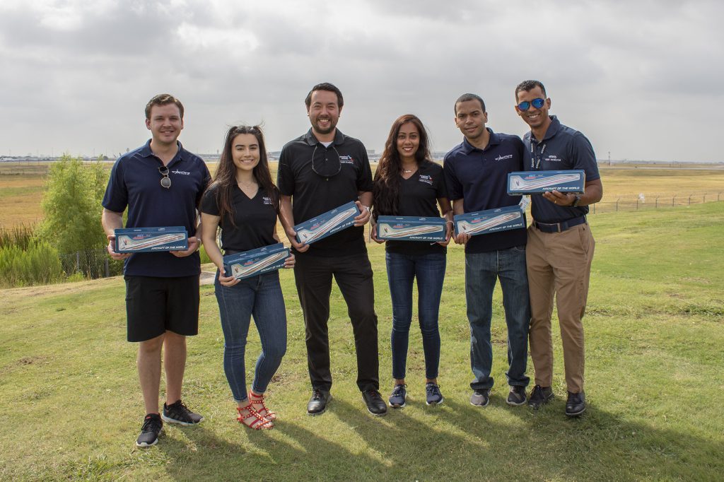 Our six winners pose with their brand new Heritage E170 model airplanes.